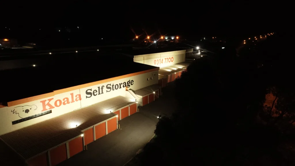 Close view of a signage wall washed evenly top to bottom by asymmetric LED floodlights