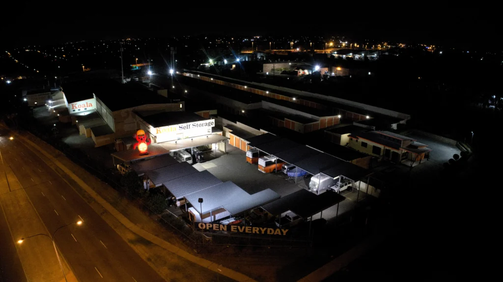 Koala Self Storage in O'Connor at night before the lighting upgrade, with harsh white floodlights and signage only partly lit