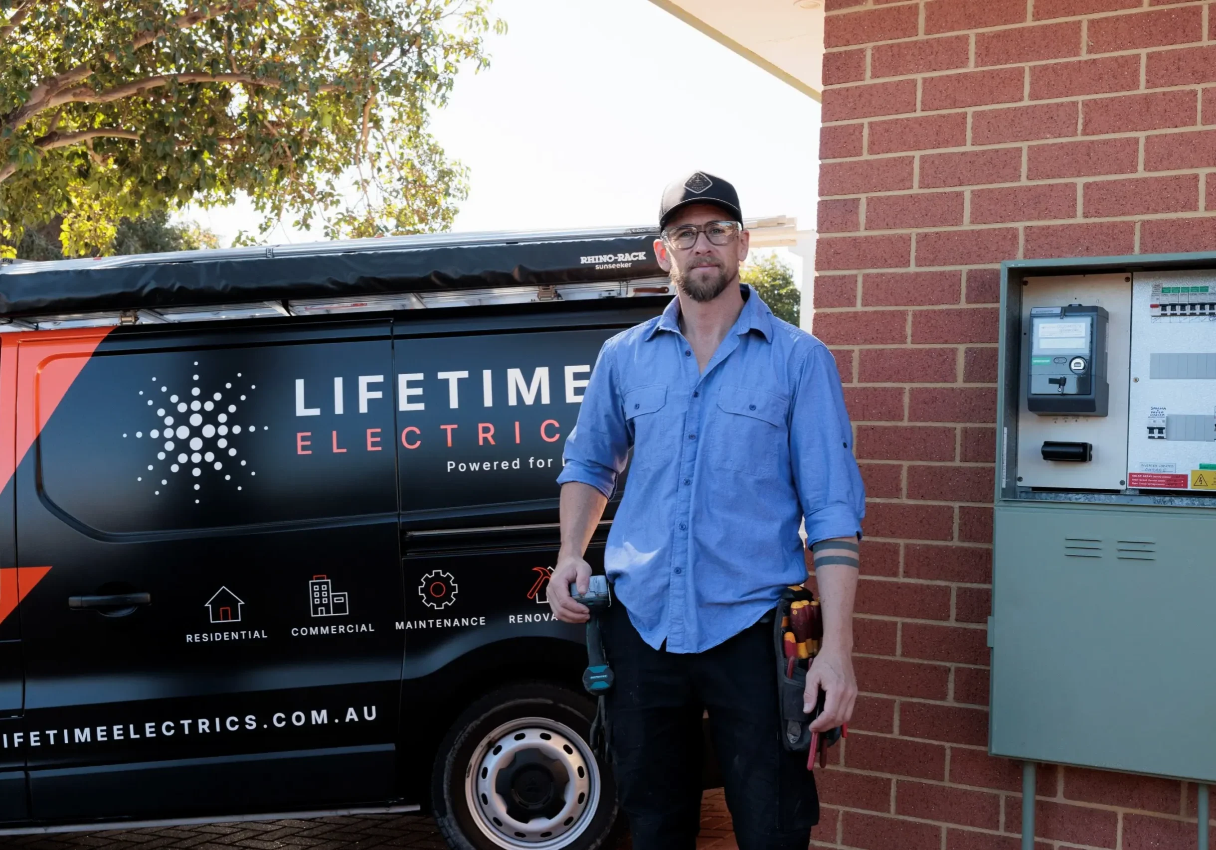 Jay Rawlings standing next to a residential switchboard