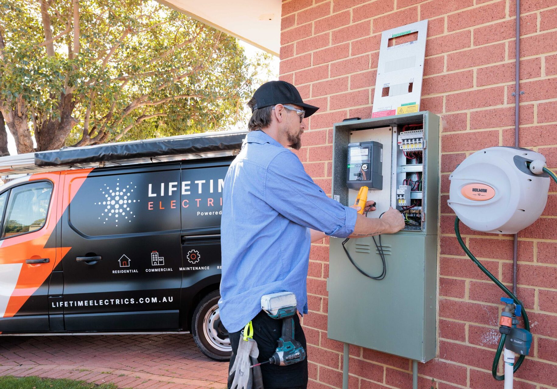 Lifetime Electrics electrician testing a meter board at a Perth home