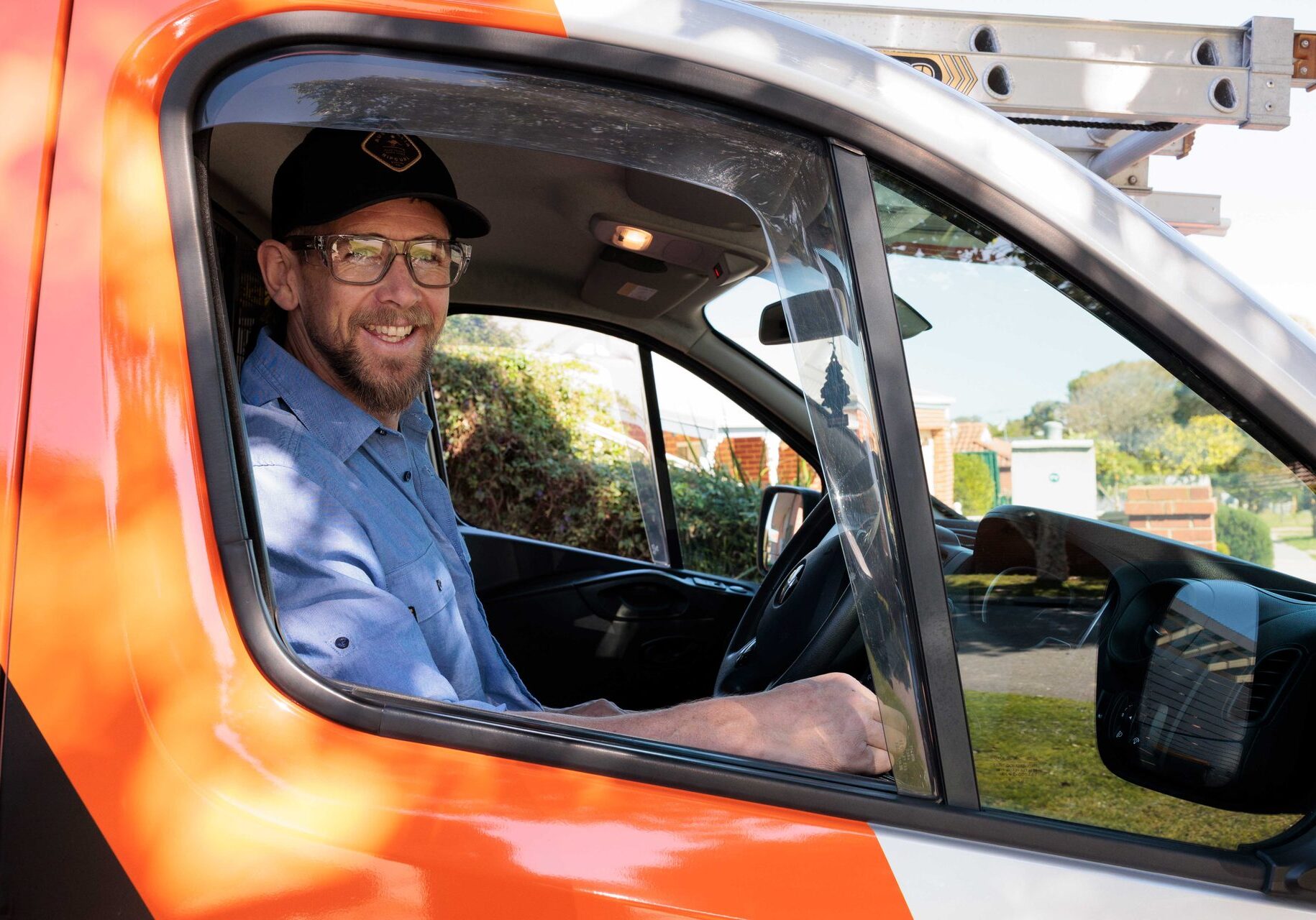 Smiling Lifetime Electrics electrician in the work van in Perth