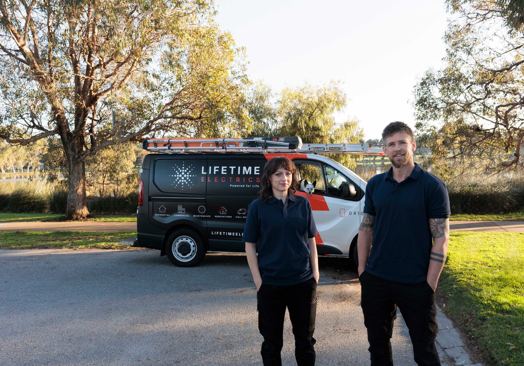 Jay and Megan of Lifetime Electrics with their van at golden hour in Perth