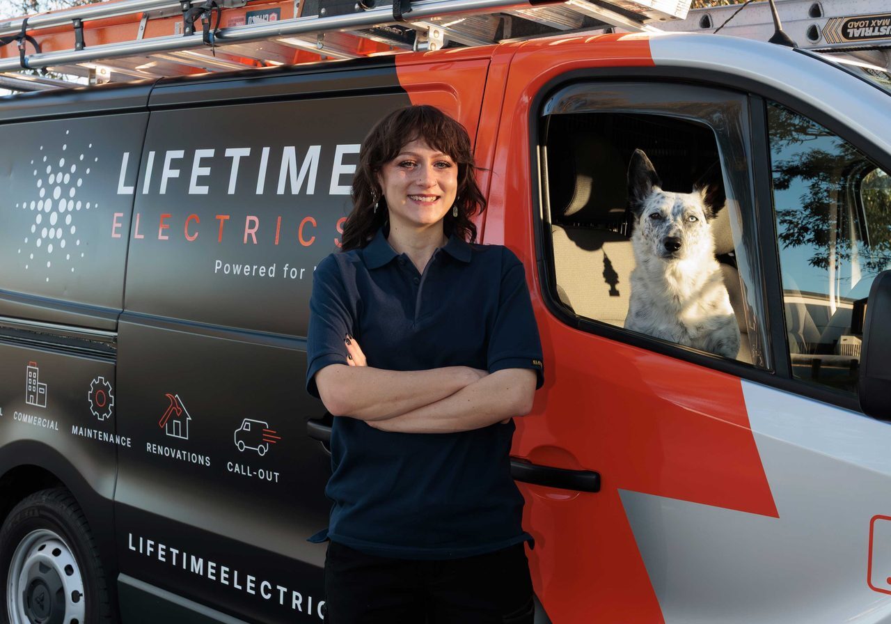 Megan of Lifetime Electrics with the van and dog in Perth
